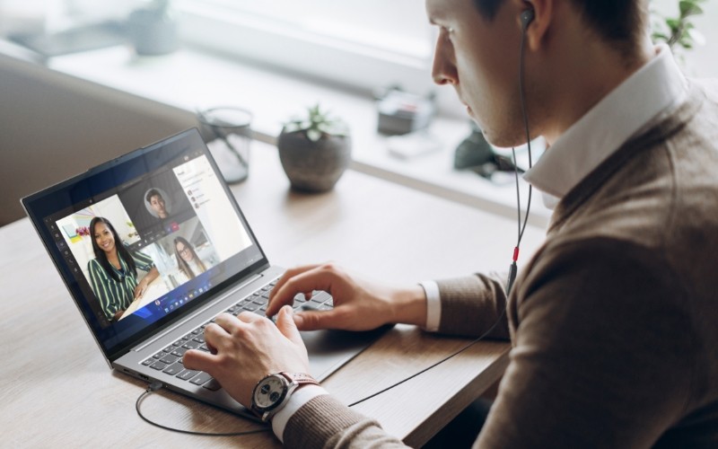 Man using a Lenovo laptop with a colleague