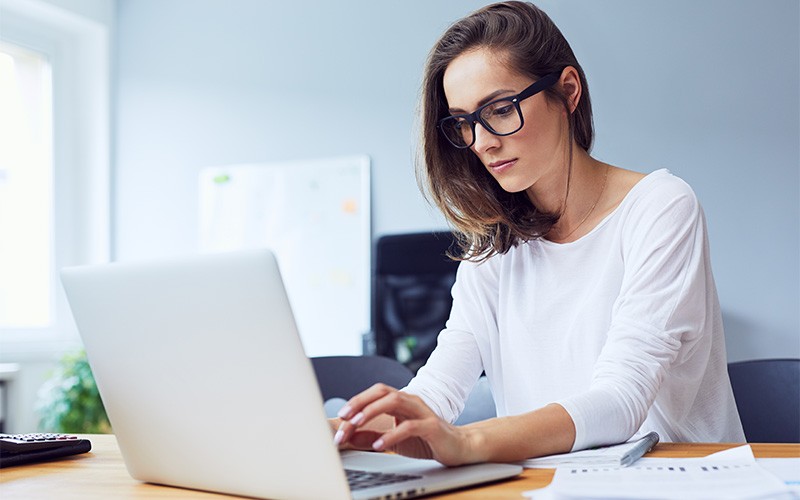 Woman working on a laptop from home